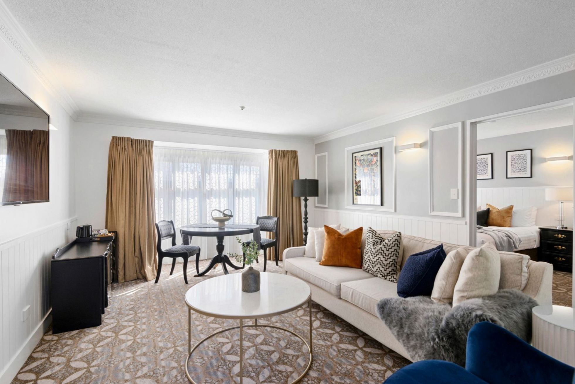 Spacious luxury suite bedroom with lake view windows at Happymotion